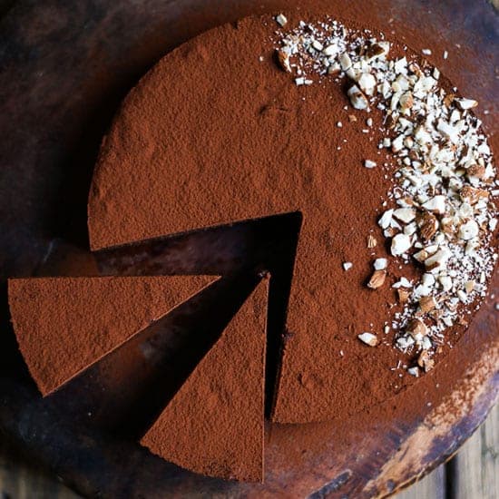 Sweet Potato Chocolate Truffle Torte with slices cut out on wooden board