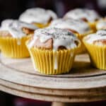 Lemon and Poppy Seed Muffins on a wooden cake stand