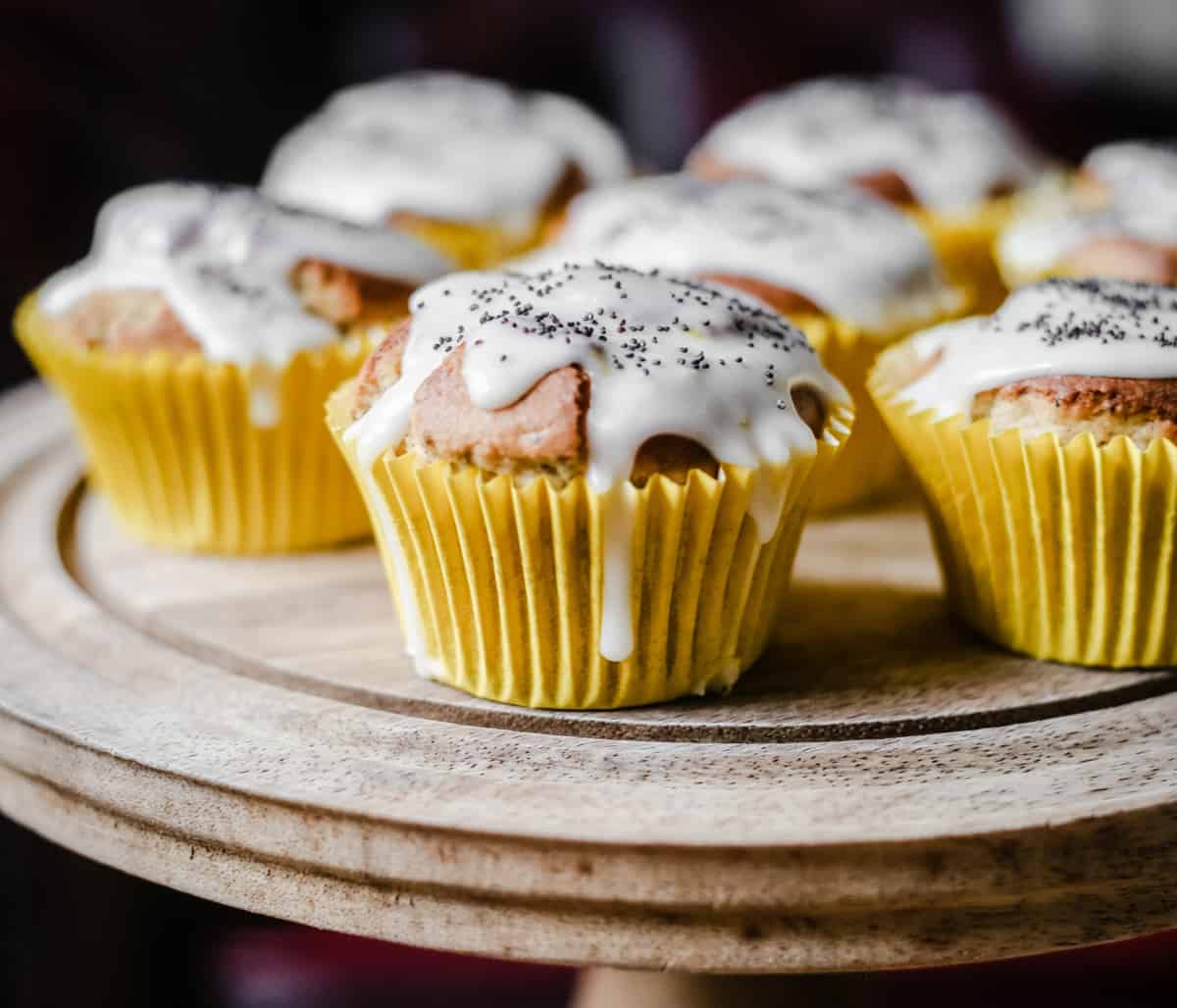 Lemon and Poppy Seed Muffins on a wooden cake stand