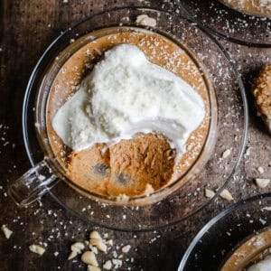 Peanut Butter Mousse in a glass tea cup on a wooden board