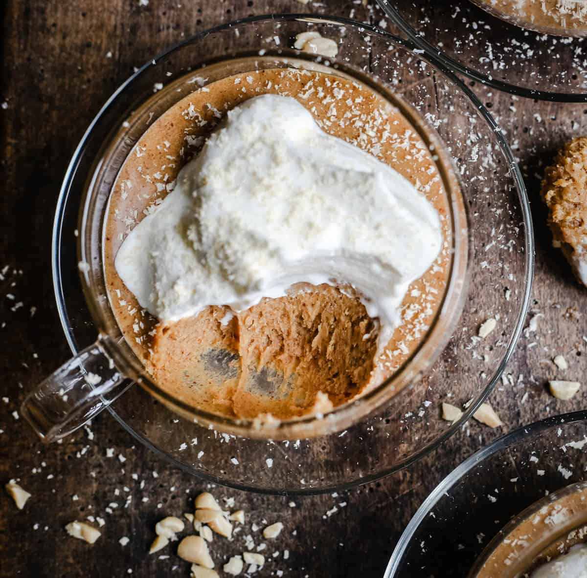Peanut Butter Mousse in a glass tea cup on a wooden board