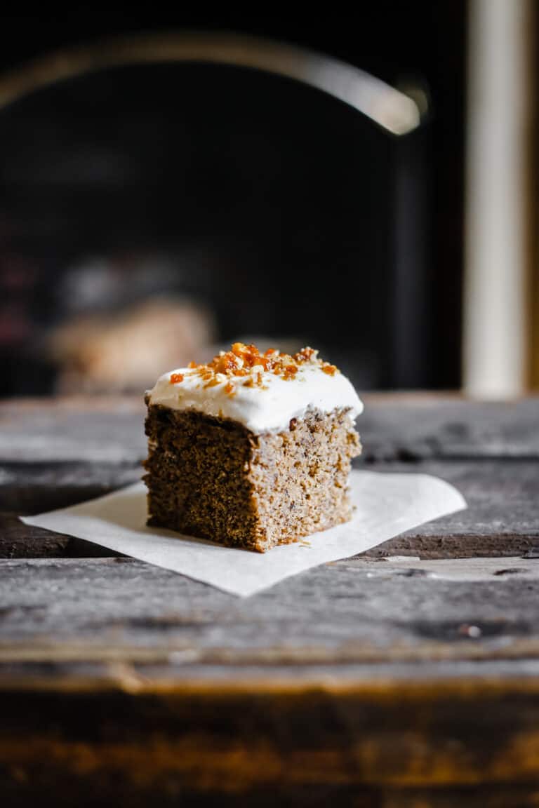 Coffee and Walnut Tres Leches Cake on a plate on a wooden table