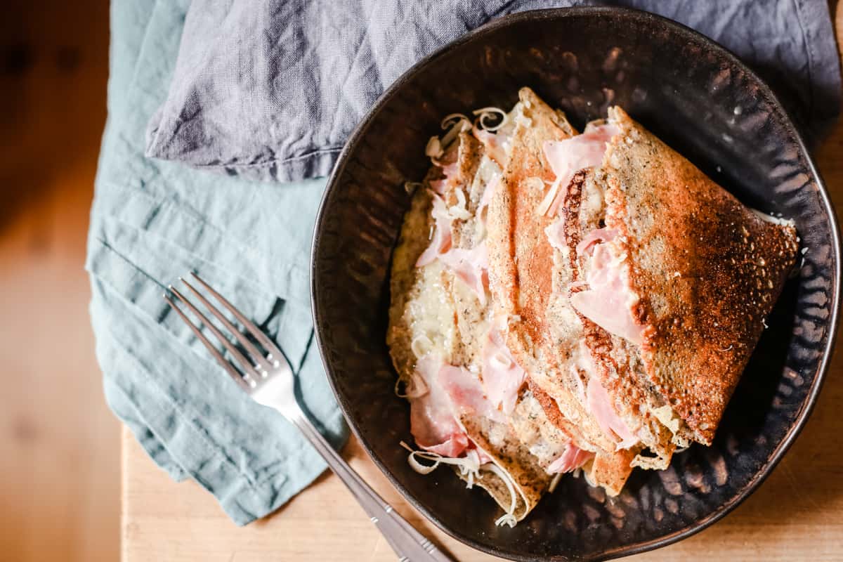 Maple Galettes with Wiltshire Ham and Gruyere in a bowl next to fork and linens