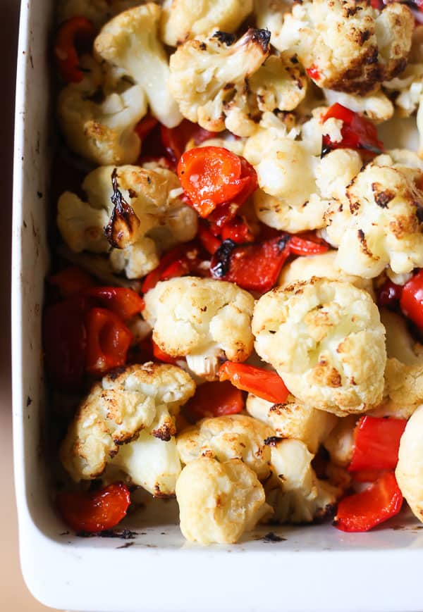 A baking dish filled with cauliflower and red pepper