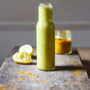 Tahini dressing in a bottle on a wooden board