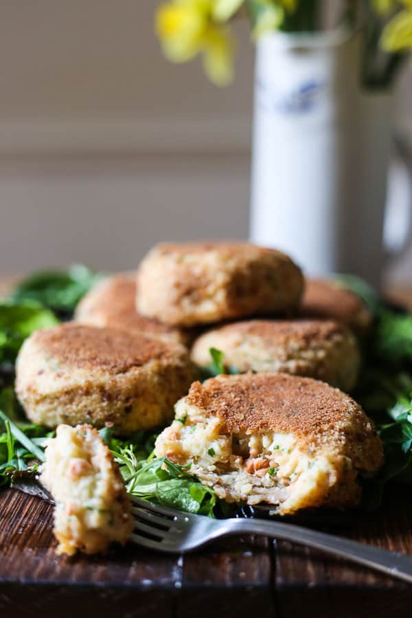 A close up of a plate of fishcakes with salad