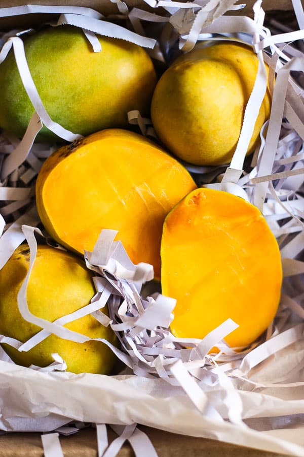 cut mangos in shredded paper