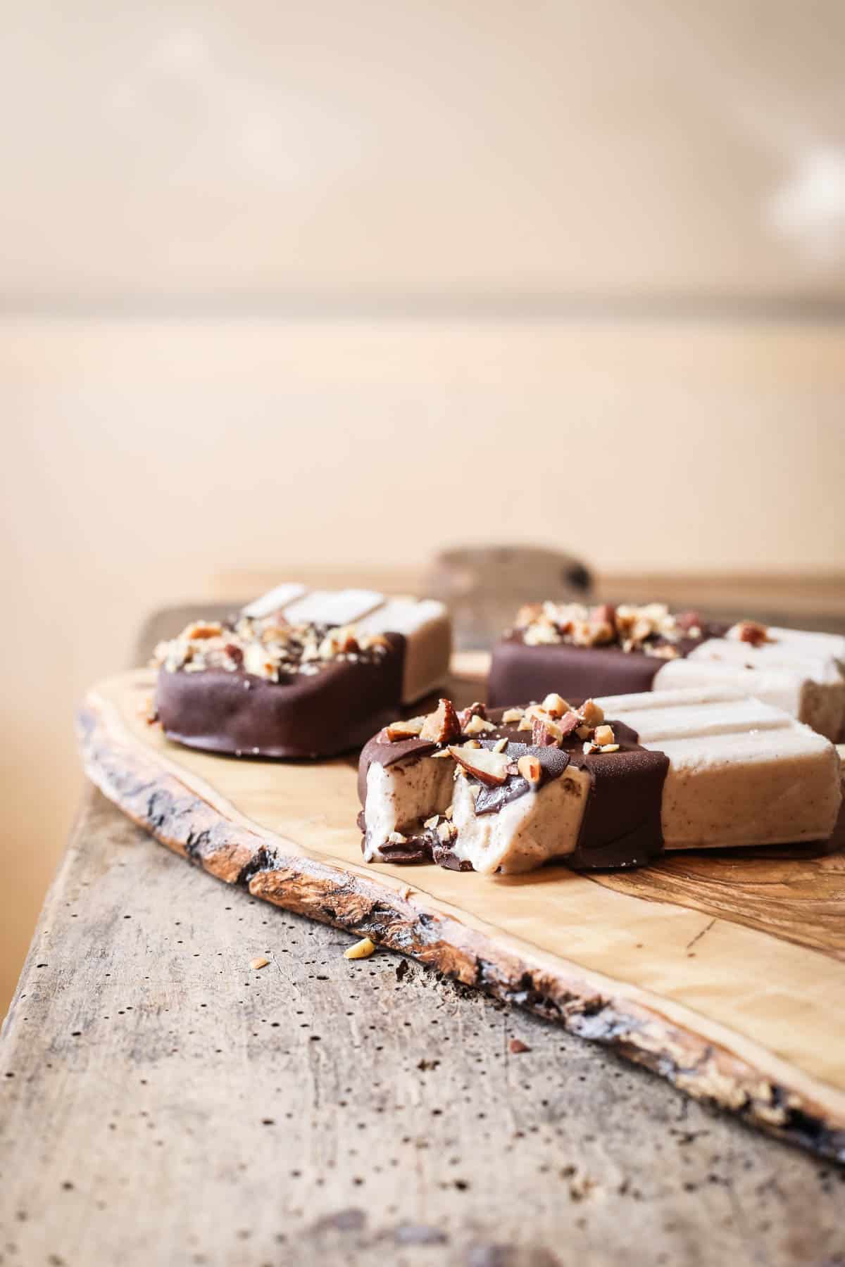 overhead shot of Almond Butter Fudgsicles on a wooden board