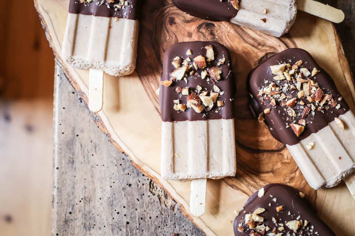 overhead shot of Almond Butter Fudgsicles on a wooden board