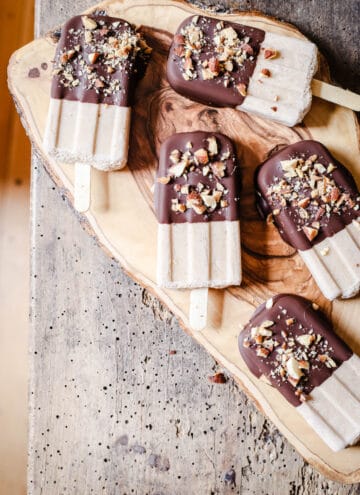 overhead shot of Almond Butter Fudgsicles on a wooden board
