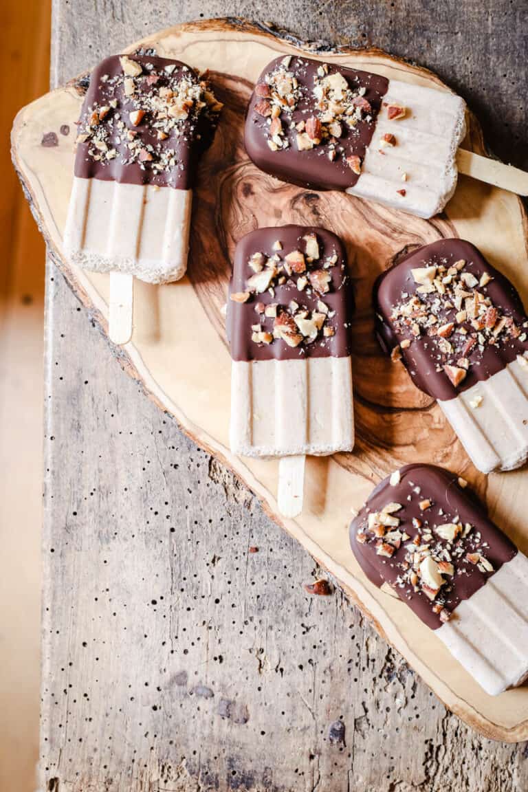 overhead shot of Almond Butter Fudgsicles on a wooden board