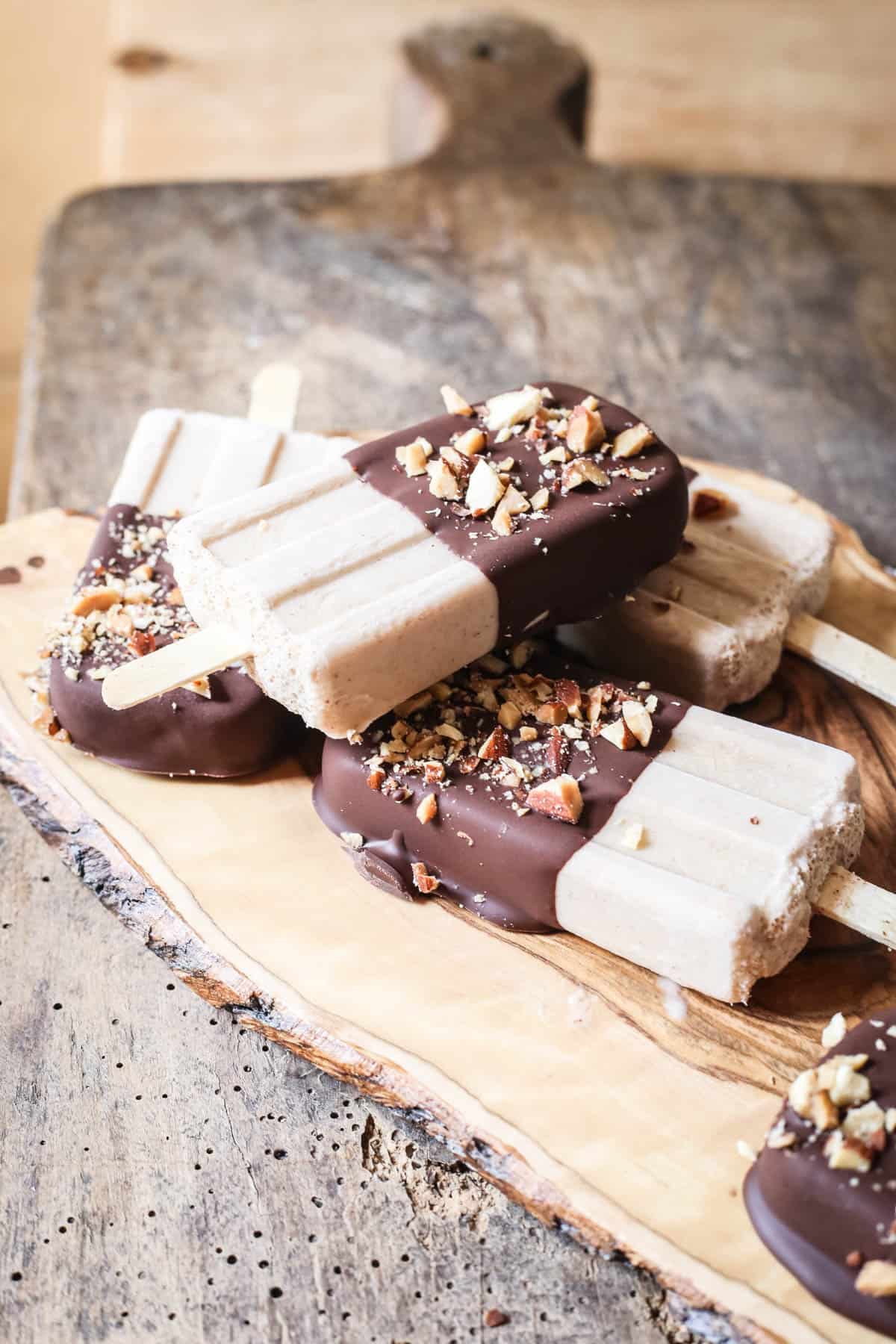 overhead shot of Almond Butter Fudgsicles on a wooden board