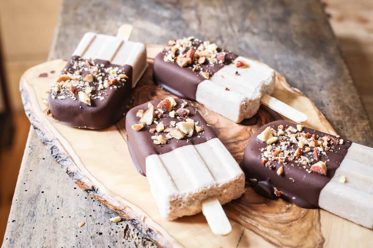 overhead shot of Almond Butter Fudgsicles on a wooden board