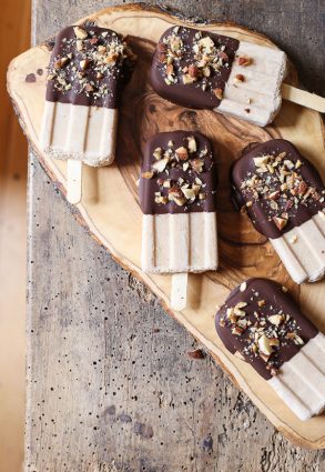 overhead shot of Almond Butter Fudgsicles on a wooden board