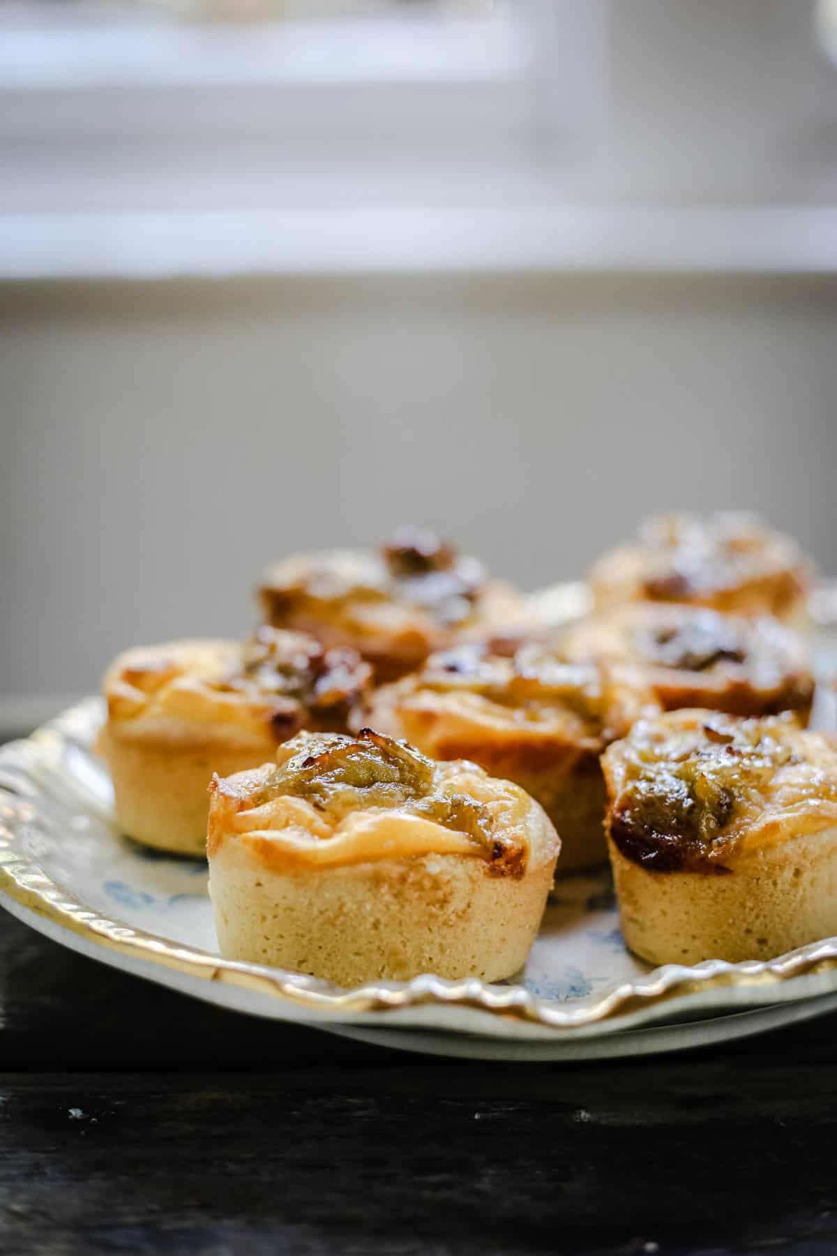 Gooseberry Friands topped with custard and fresh gooseberry jam.