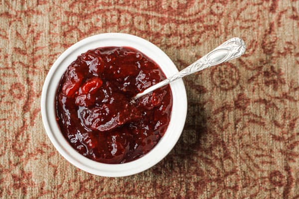 A ramekin of jam on a table