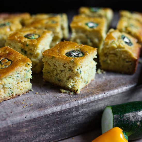 Jalapeno Honey Courgette Cornbread Jalapeno Honey Courgette Cornbread on a wooden board with a knife next to courgette and jalapenos