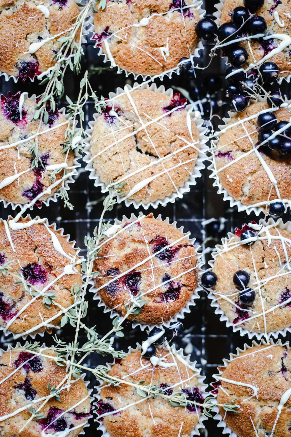 overhead of Blackcurrant White Chocolate and Thyme Muffins on a wooden table