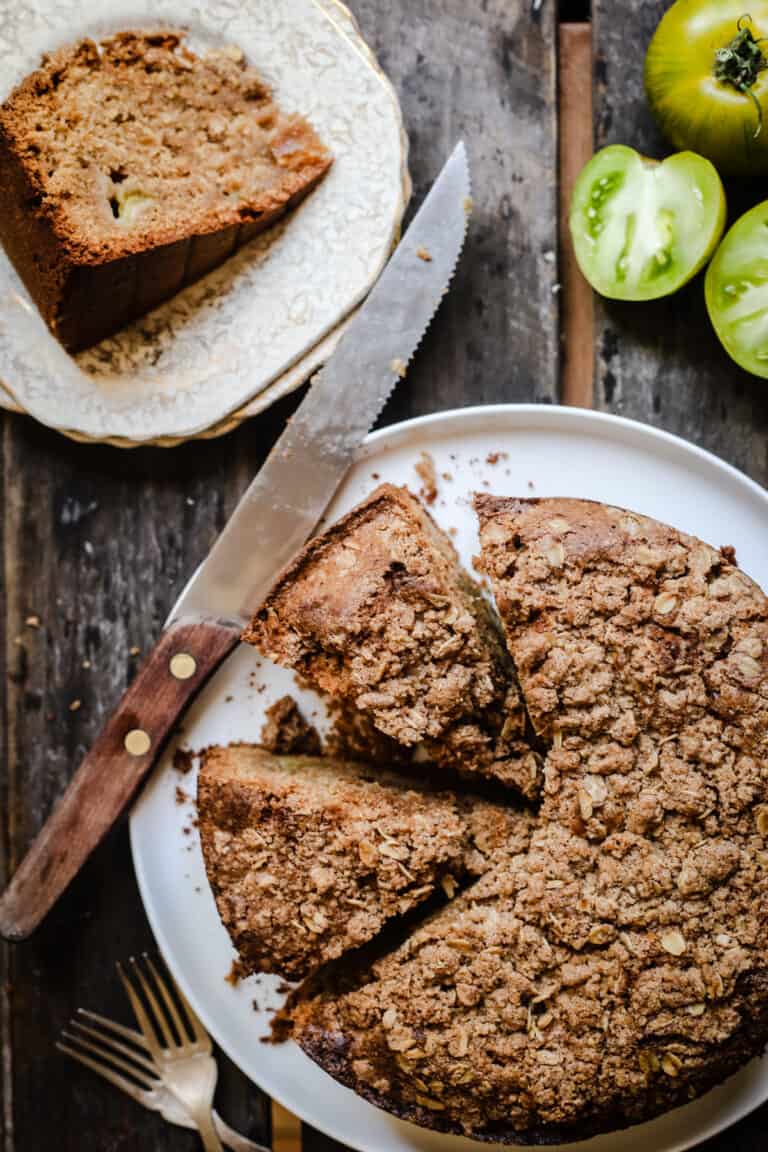 overhead shot of Green Tomato and Stem Ginger Cake with Streusel Topping {gluten-free} on a plate with green tomatoes next to it