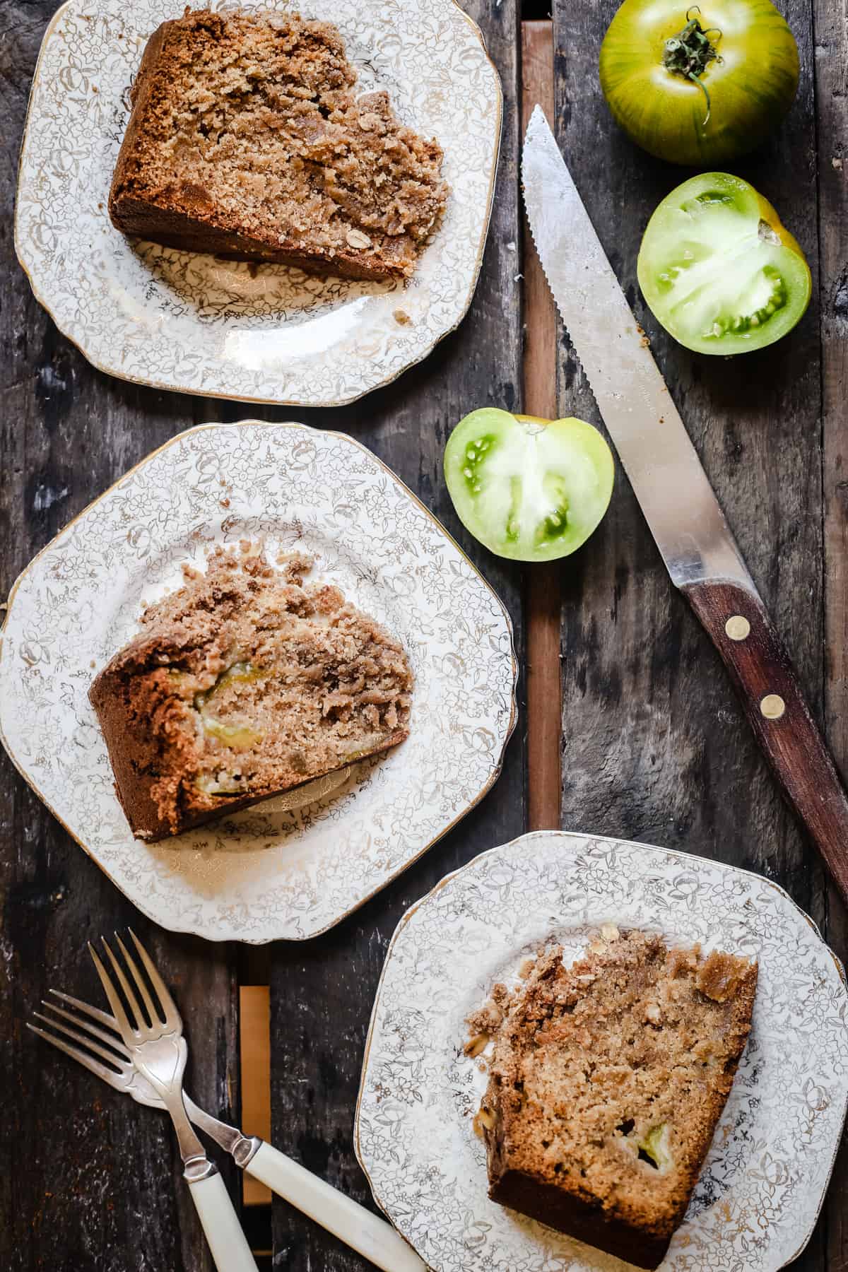 overhead shot of slices of Green Tomato and Stem Ginger Cake with Streusel Topping {gluten-free} on a plate with green tomatoes next to it