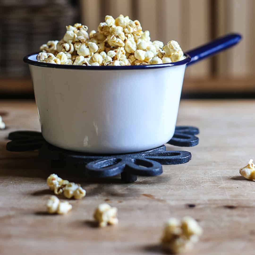 Buttered Maple and Bacon Salt Popcorn in a saucepan on a table