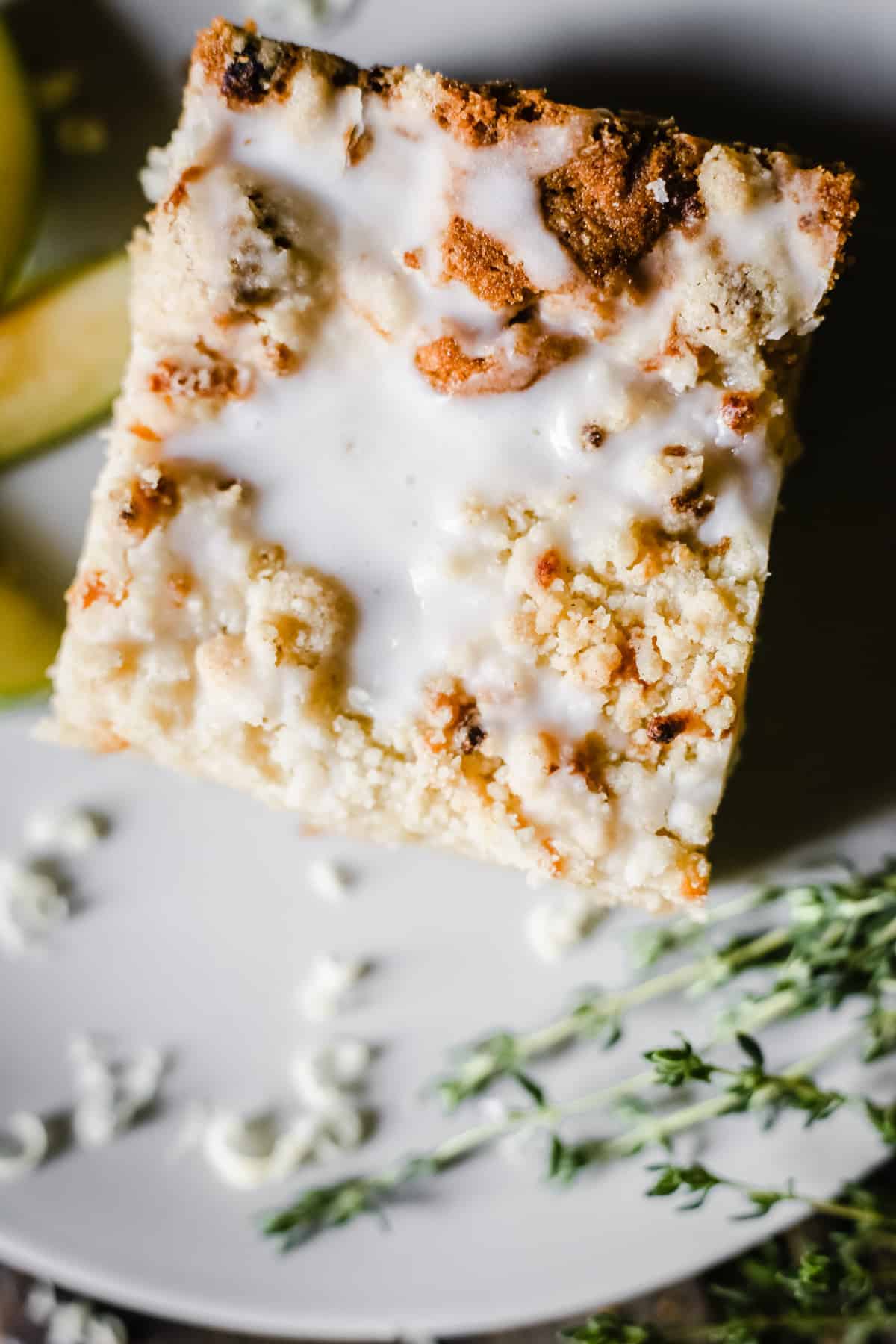 A slice of Apple Cheddar Thyme Crumble Cake on a plate