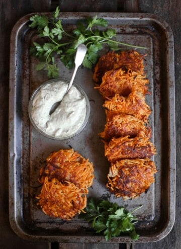 overhead shot of Sweet Potato and Bacon Rosti on a metal tray with tahini sauce
