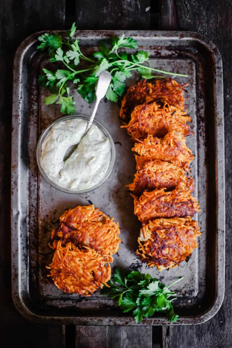 Sweet Potato Rosti with Bacon on a baking tray with dip.