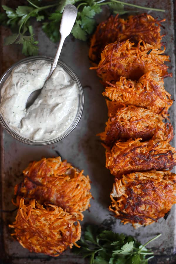 overhead shot of Sweet Potato and Bacon Rosti on a metal tray with tahini sauce