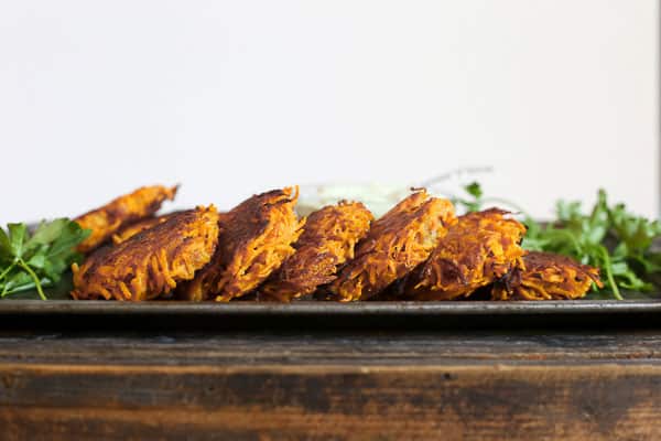 straight on shot of Sweet Potato and Bacon Rosti on a metal tray with tahini sauce