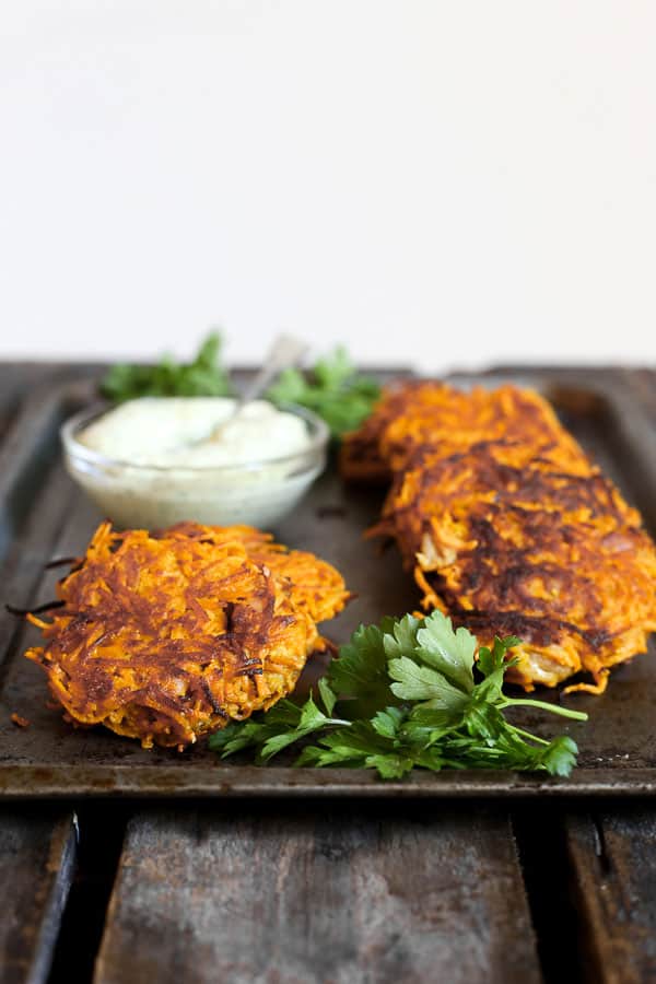 straight on shot of Sweet Potato and Bacon Rosti on a metal tray with tahini sauce