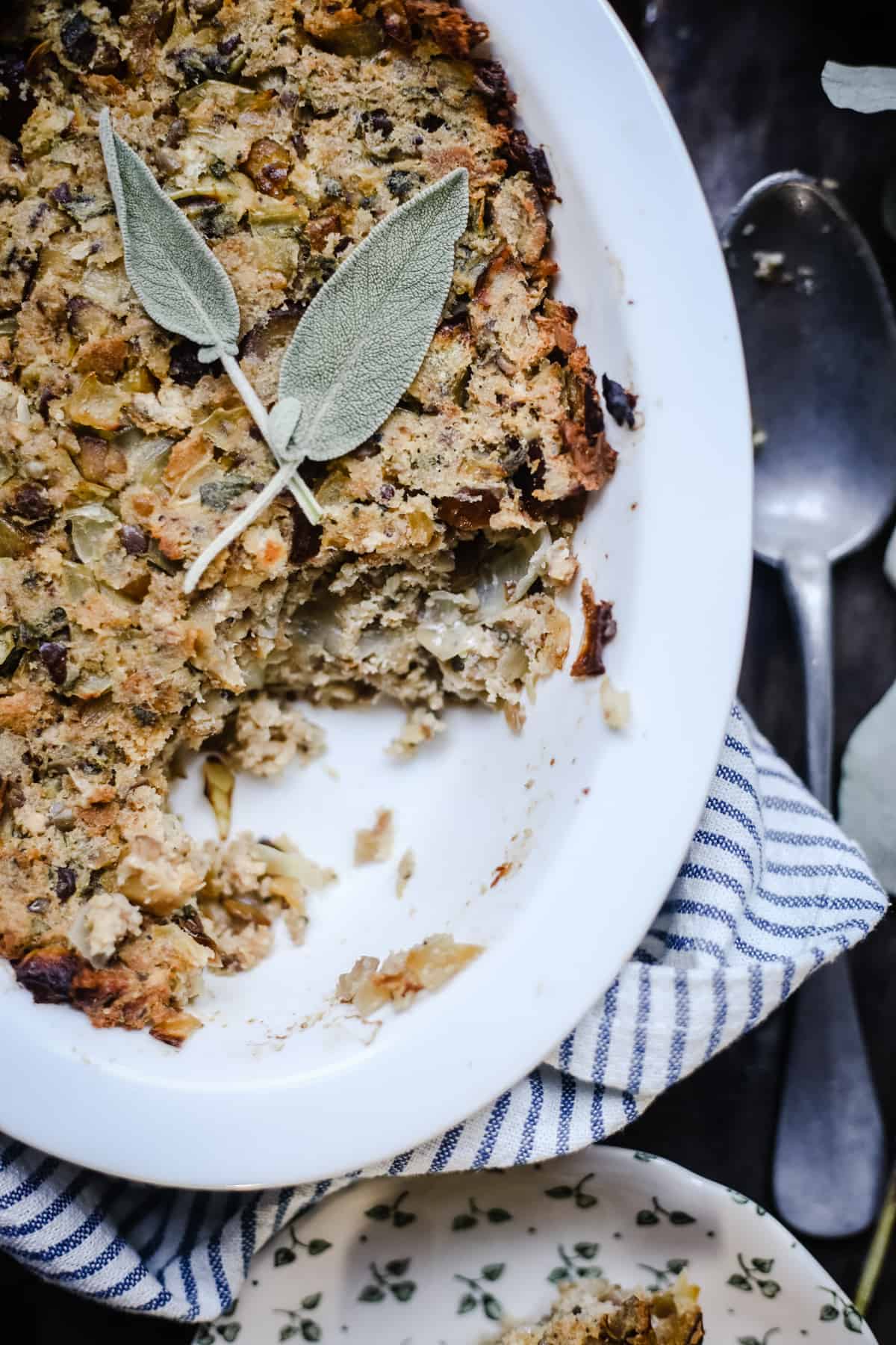 Sage Chestnut Stuffing in a dish with a portion taken ut