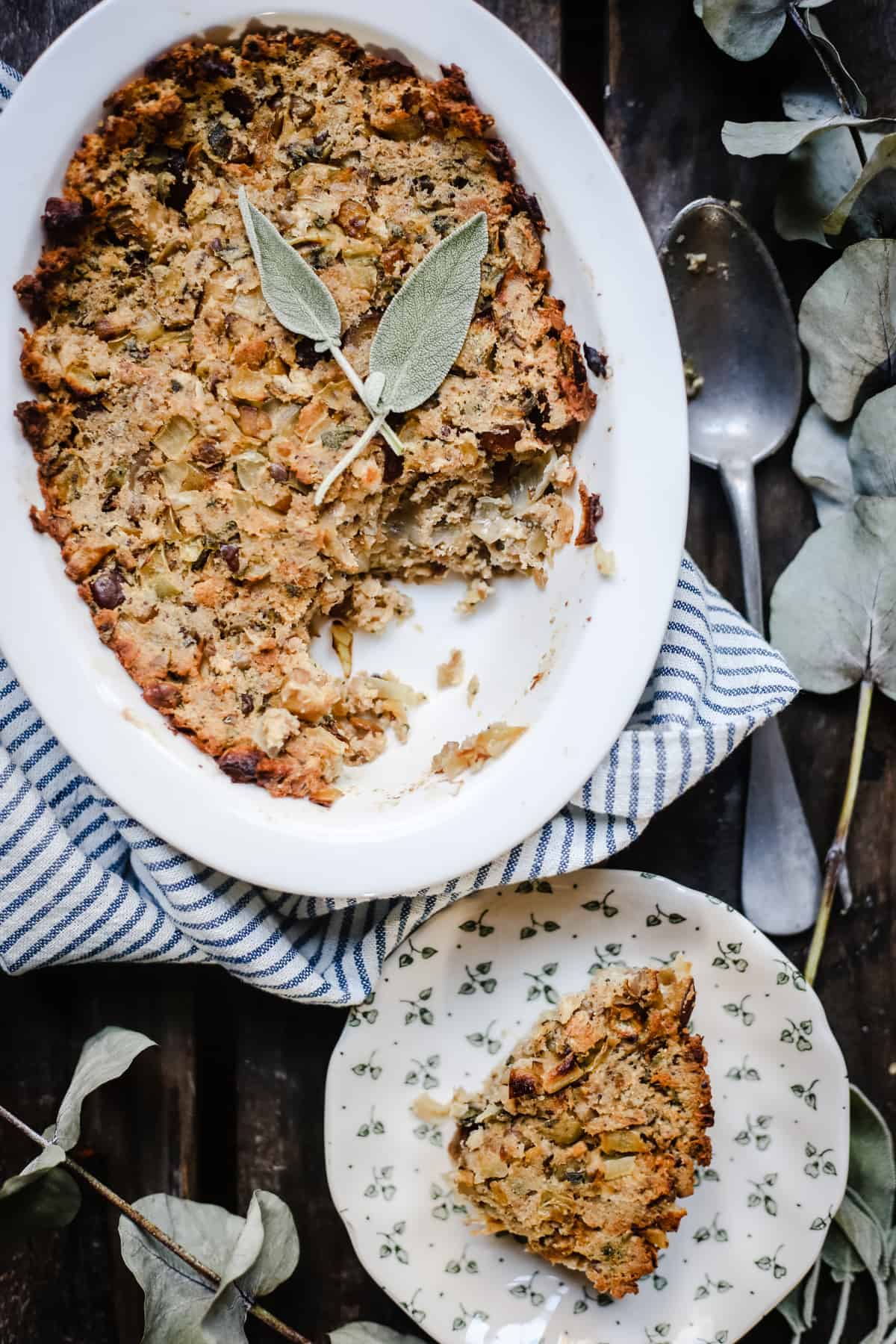 A dish of stuffing in the background with a plate of stuffing in front