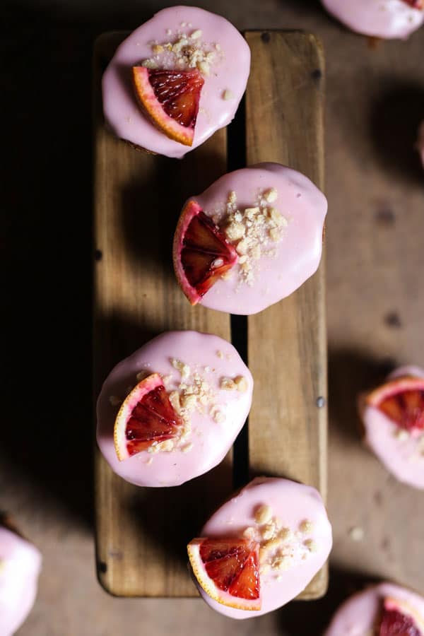 overview of Blood Orange Buckwheat Hazelnut Friands resting on a wooden box