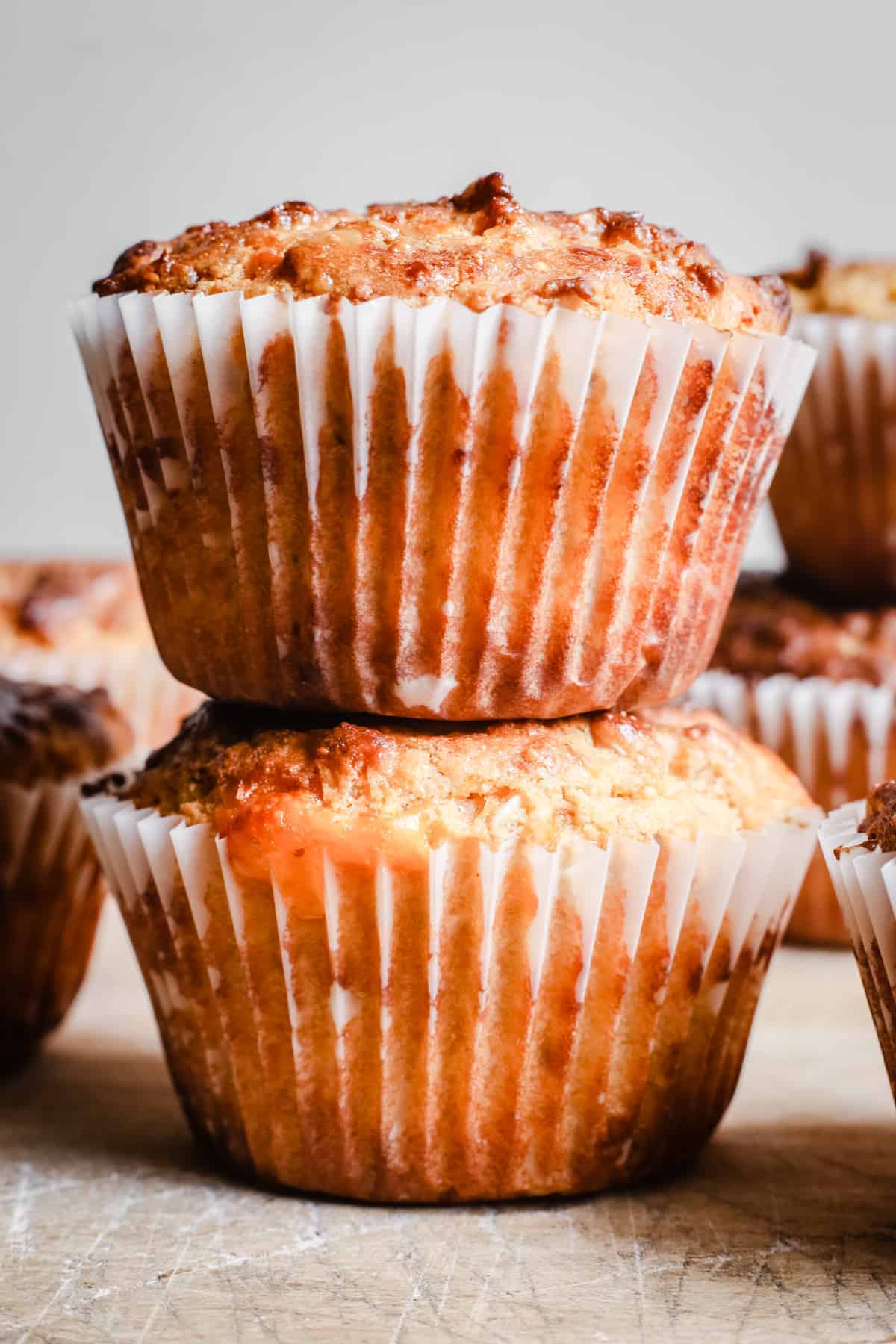 Cheesy Oat Bacon Breakfast Muffins stacked on a wooden board