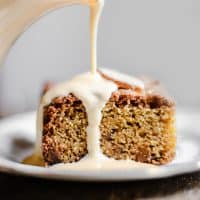 Lemon and Ginger Cake on a plate being drizzled with lemon custard