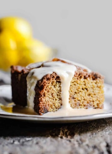 Lemon and Ginger Cake on a plate drizzled with lemon custard