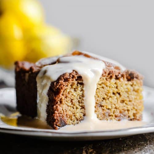 Lemon and Ginger Cake on a plate drizzled with lemon custard