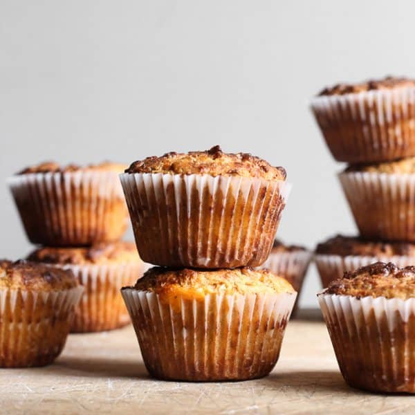 Cheesy Oat Bacon Breakfast Muffins stacked on a wooden board