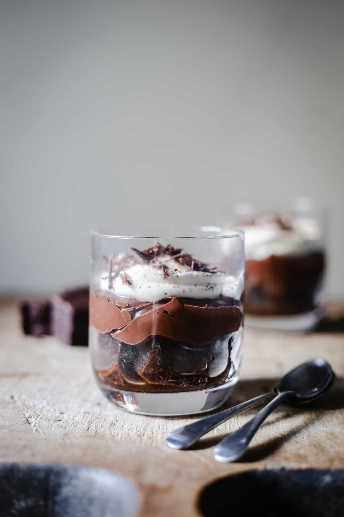 Chocolate Brownie Mousse Trifle on a wooden board with spoons