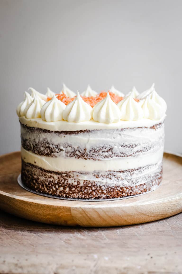 gluten-free carrot cake on a wooden plate on a table