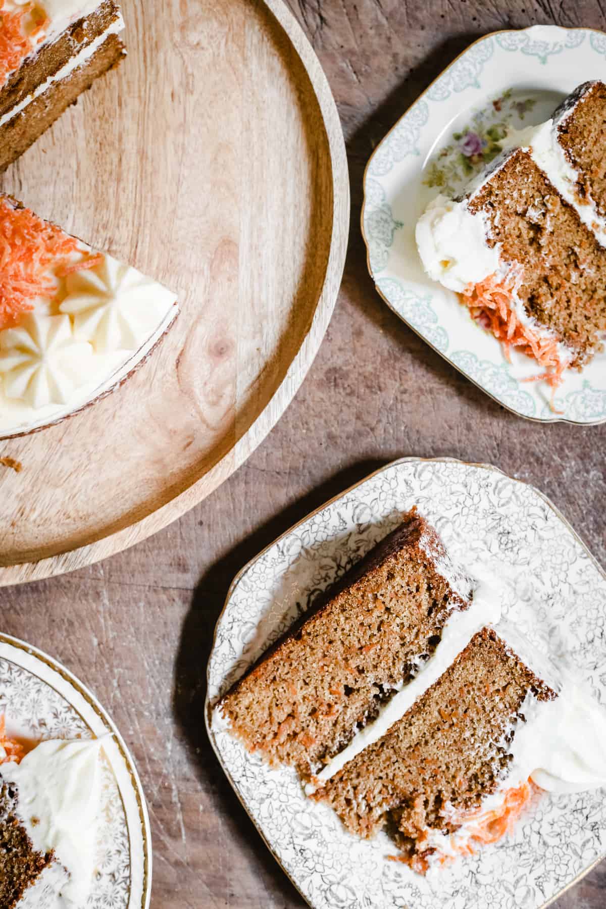 overview of a cut gluten-free carrot cake with slices on plates next to it