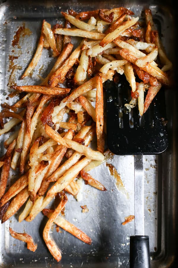 chips in a roasting dish with a spatula