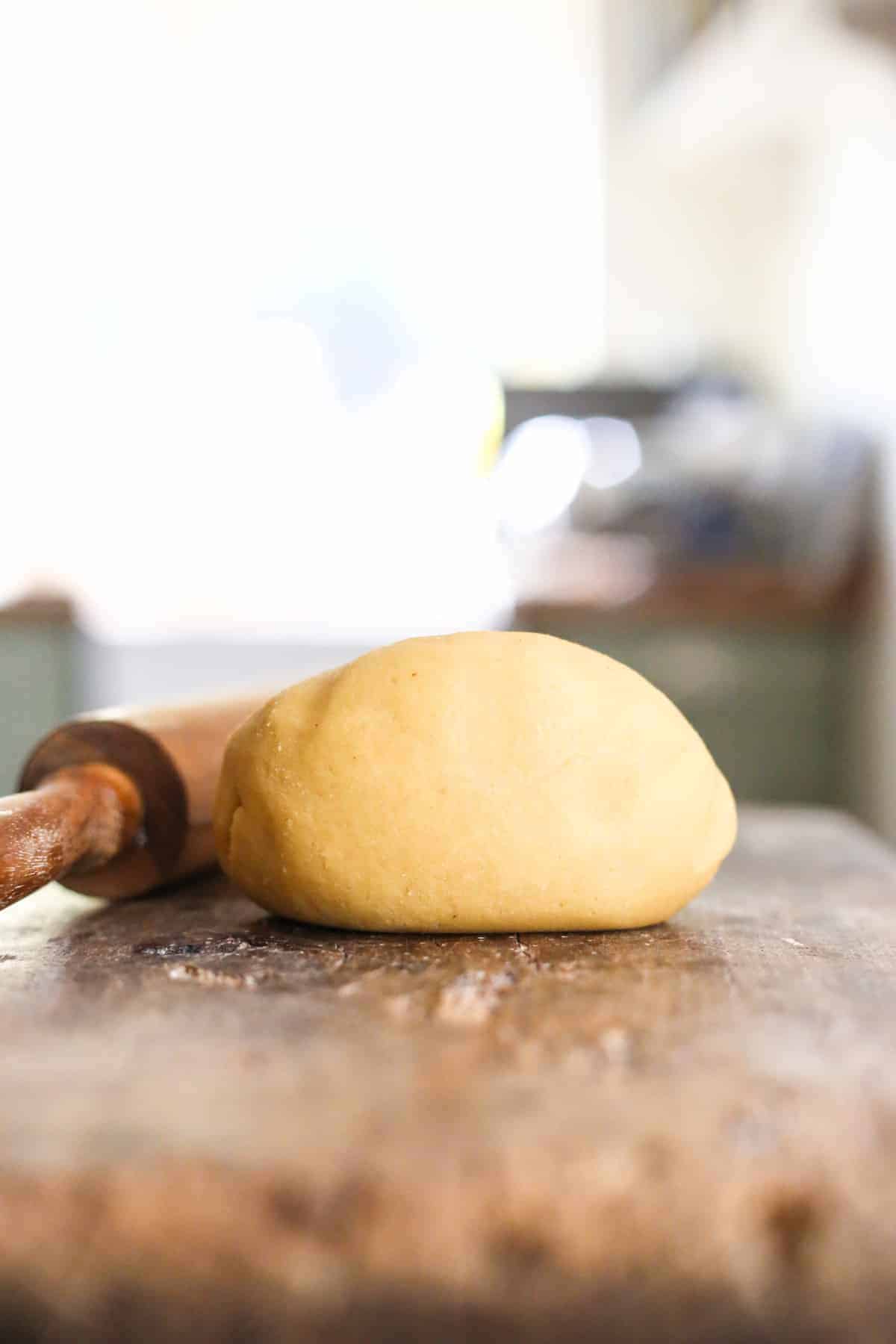 homemade marzipan dough on a wooden board