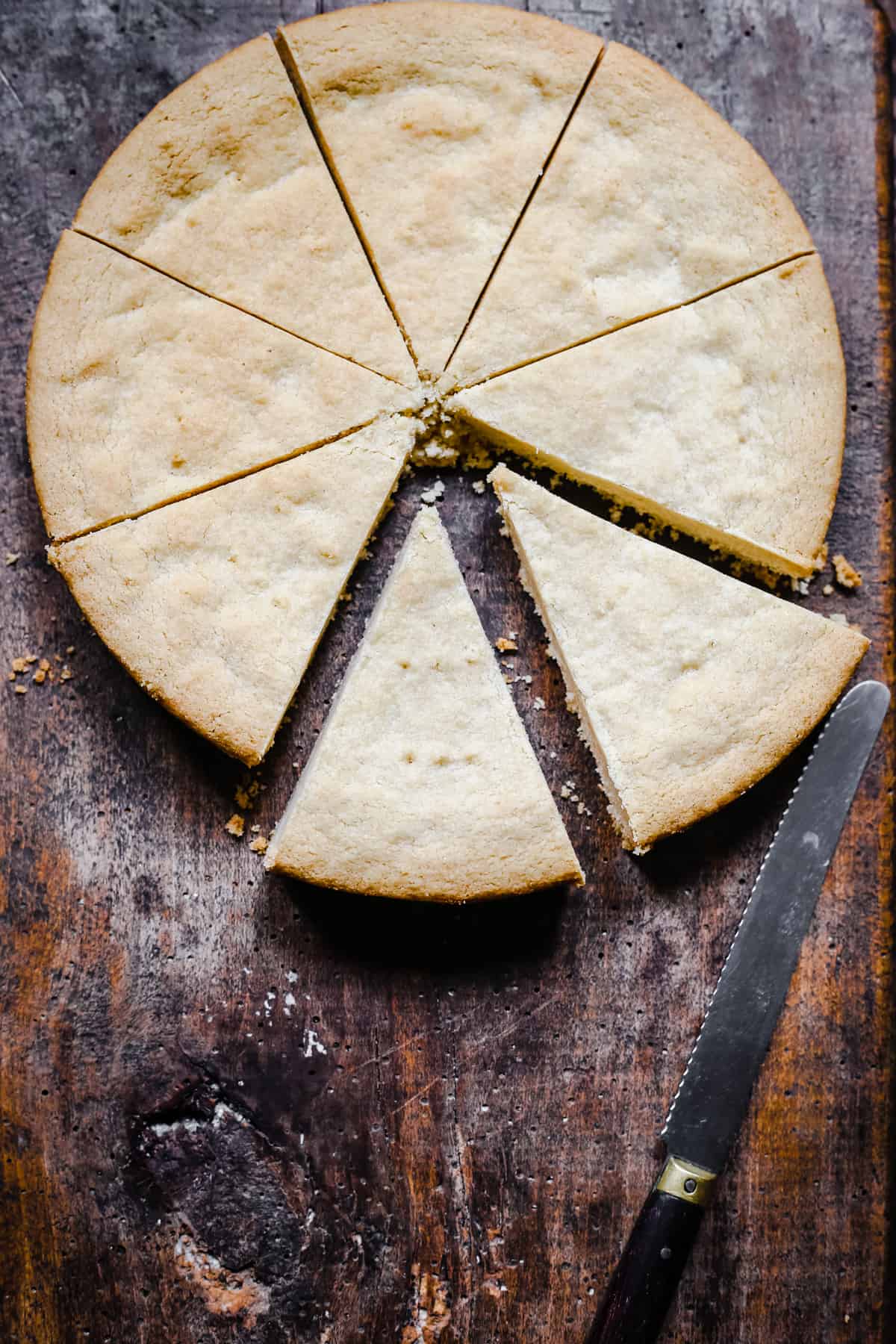 Gluten-free shortbread on a wooden board cut into pieces