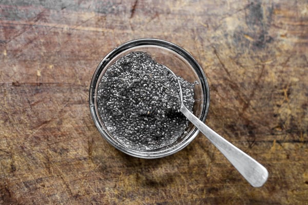 A close up of a glass bowl of chia seeds