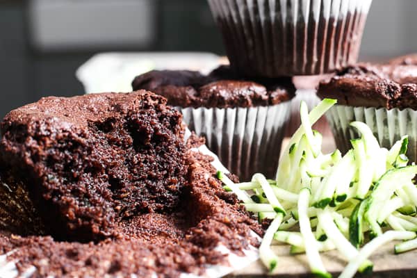 A close up of a halved chocolate muffin on a table