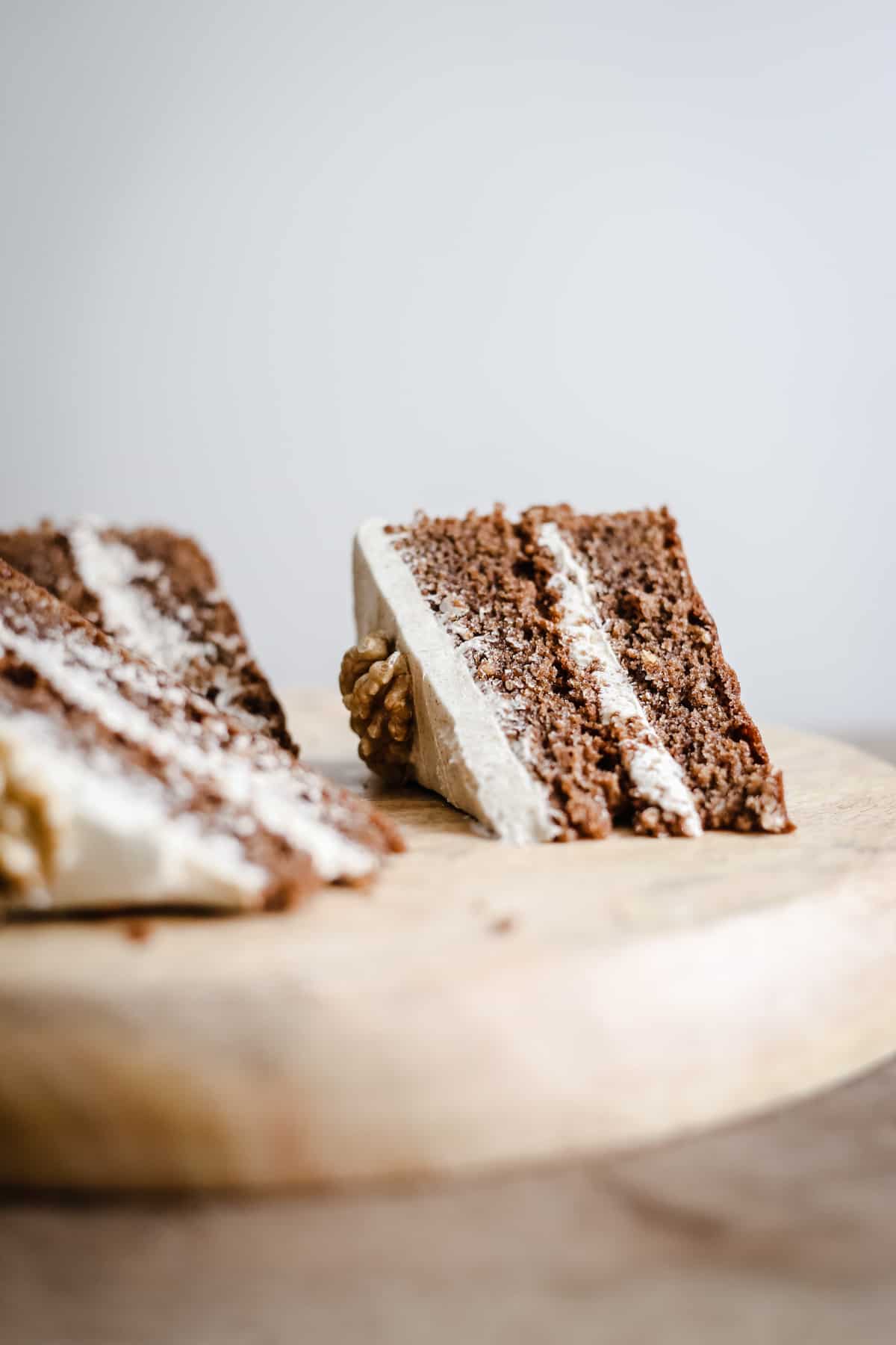 Slices of gluten-free Coffee and Walnut Cake on a wooden board