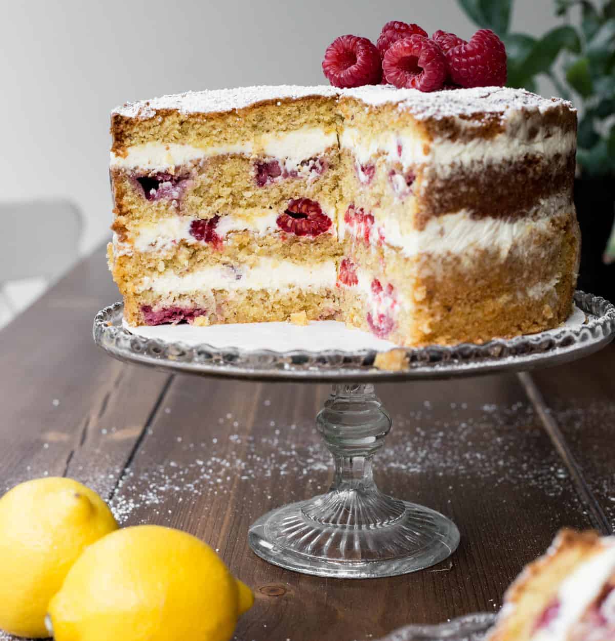 Cut Lemon Raspberry Cake on a cake stand