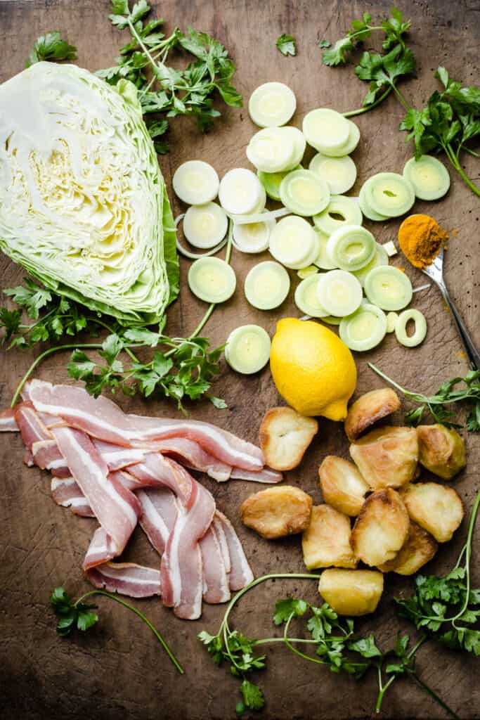 Ingredients for Bubble and Squeak on a wooden board